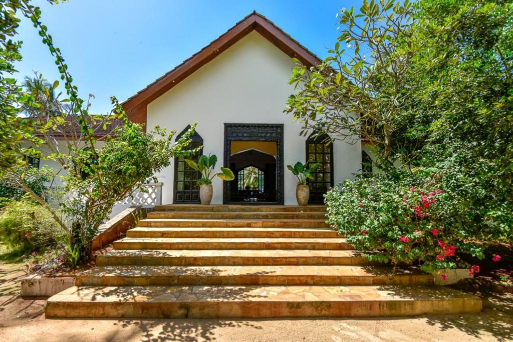 Villa facade with traditional carved Zanzibari entrance doorway